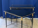 an image of a glass and brass coffee table on a wooden floor