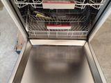 a dishwasher that is sitting in the middle of a kitchen