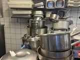 pots and pans stacked on top of each other in a kitchen