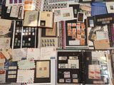 many different types of stamps and envelopes laid out on a table