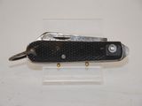a small black pocket knife on a clear stand