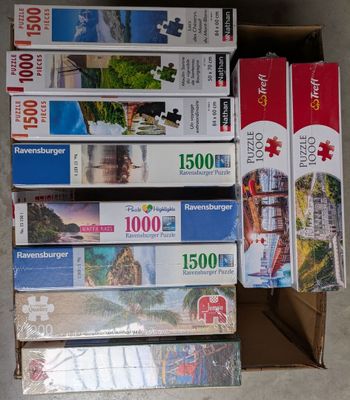 many different puzzles in a box on the floor