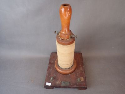 un objet en bois surmonté d'une bobine de fil