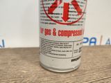 a can of soda sitting on a table next to a wall