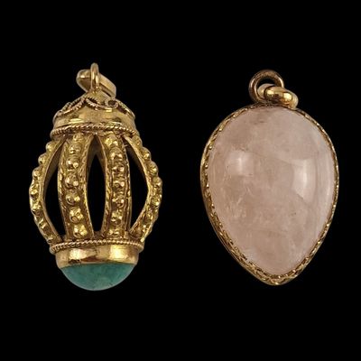 two gold and jade pendants, one with a crown and the other with a rose quartz stone