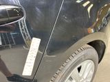 a sticker on the door of a car that is parked in a parking lot
