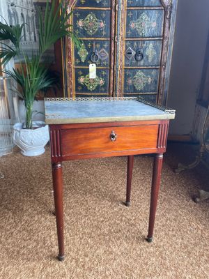 a small table with a marble top and wooden legs