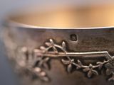 a silver bowl with a design on it on a table