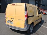 a yellow van that is parked in a parking lot