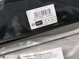 a black bag with a label on it sitting on a table