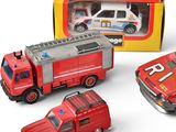 four toy firetrucks and a fire truck in a box