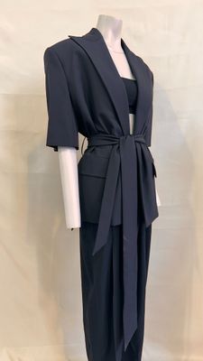 the mannequin is wearing a black suit with a tie around the waist