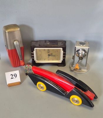 a toy car with a clock and other items on a table