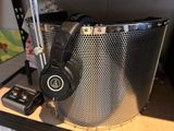microphone and headphones in a metal basket on a table