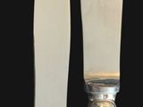 two knives that are next to each other on a black background