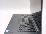 a laptop computer that is open on a white surface