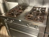 a stove with a pot on top of it in a kitchen