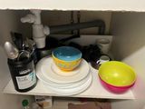 a picture of a cluttered kitchen cupboard with dishes and utensils