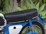 a blue and white motorcycle parked on the side of the road