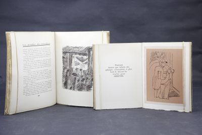 three open books with drawings on them sitting on a table