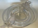 a glass ashtray with a bird on top of it