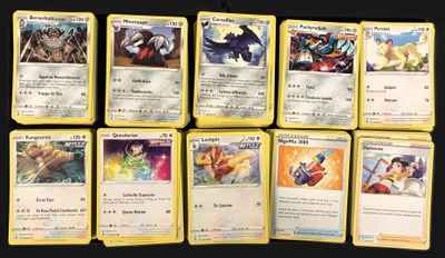 pokemon cards are lined up on a black surface