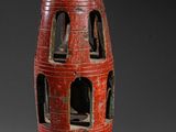 a red vase that is sitting on a table