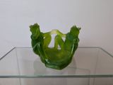 a glass table with a green vase on top of it