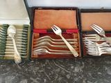 a lot of forks and spoons in a case