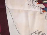 a picture of a table cloth with a picture of a house on it