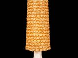 a white table lamp with a yellow shade on it