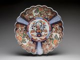 an orange, blue and white plate with a floral design on it