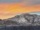 a picture of a picture of a mountain with a sunset in the background
