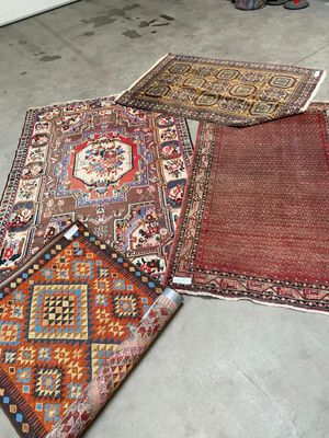 several rugs are laid out on the floor in a room