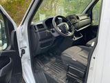 a white truck with the door open and the driver ' s seat down