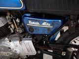 a close up of a blue motorcycle with a black seat