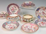 many different plates and cups and saucers on the table