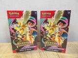 deux paquets de cartes à collectionner Pokémon posés sur une table en bois