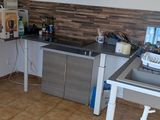 a kitchen with a stove, sink, and refrigerator in it