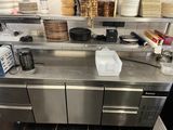 many plates and pans on the counter in the kitchen