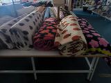 many blankets on a table in a store