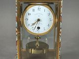 a clock that is sitting on a stand on a table