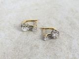 pair of diamond stud earrings on a marble surface