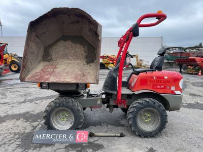a red tractor with a large dump truck behind it