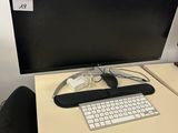 a desk with a keyboard and a monitor on it