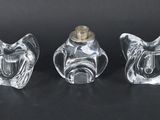 three clear glass figurines sitting on top of a black surface