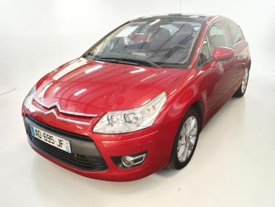 the red citrole is parked in a white room