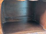 a wooden shelf with a clock on top of it