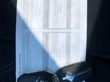 a car key sitting on top of a piece of paper with a yellow tag