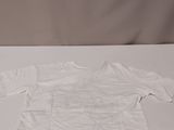 a white shirt sitting on a white table